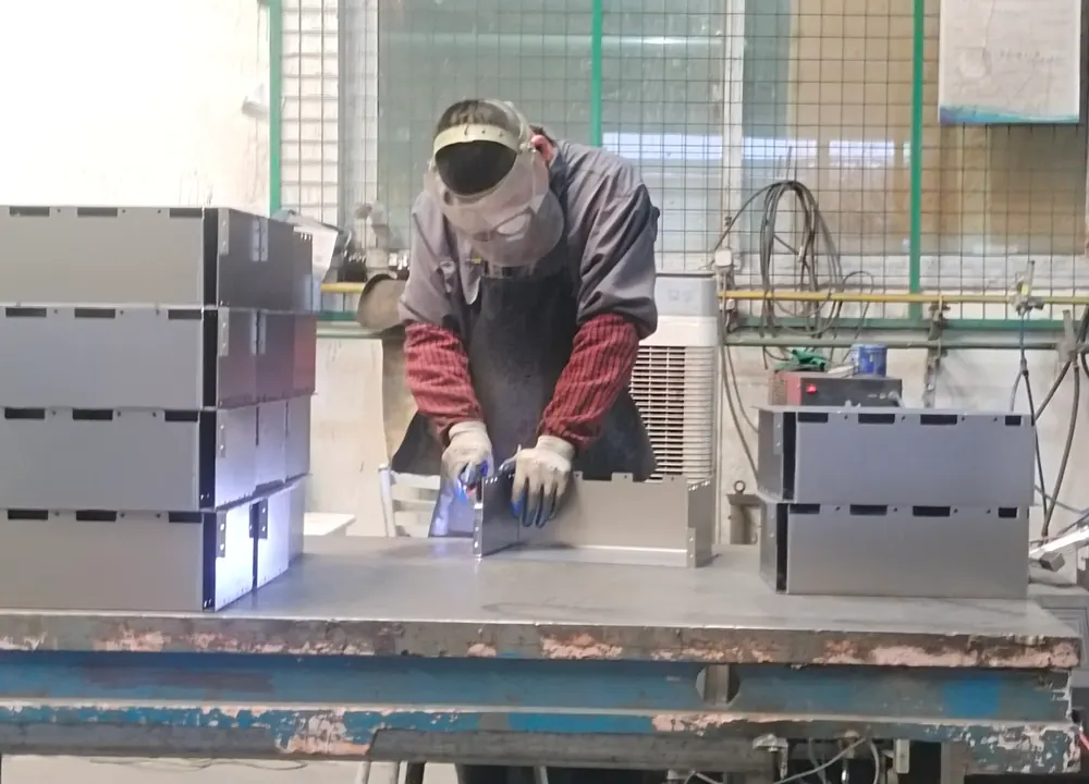 Welded stainless steel frames arranged for batch inspection.