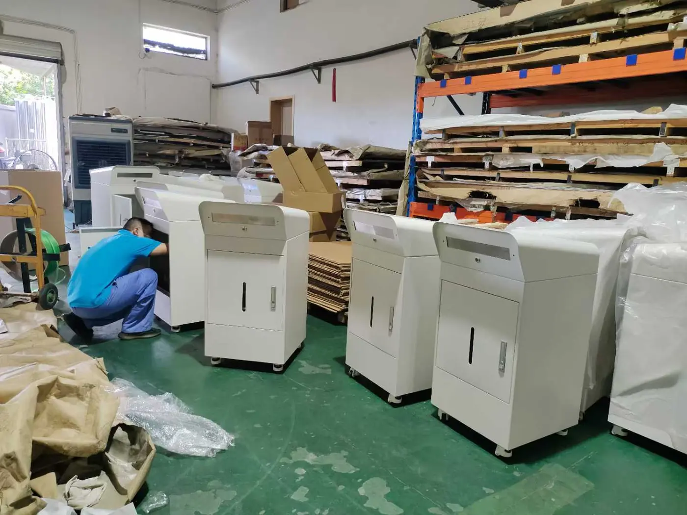 Workers checking assembled custom metal cabinets