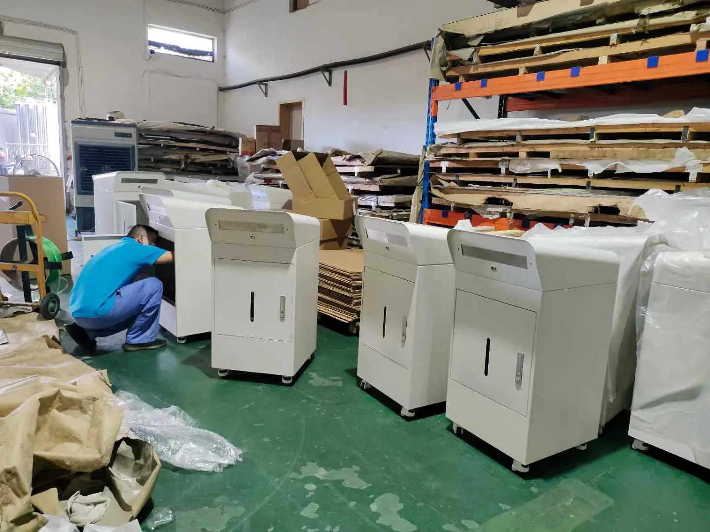Worker assembling and checking powder-coated sheet metal cabinets on the Fulei Metal production floor