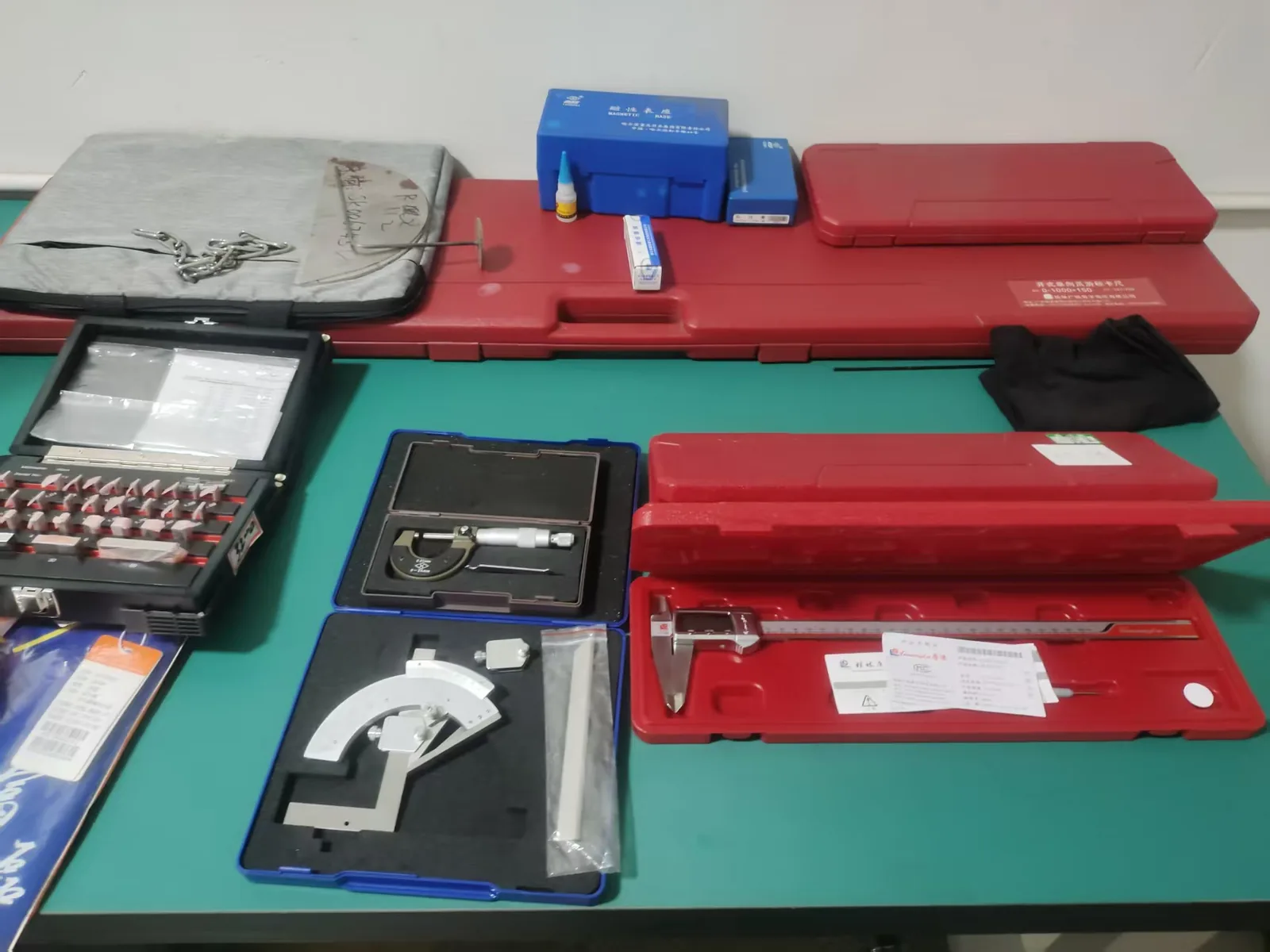 Vernier calipers and height gauge staged for dimensional inspection