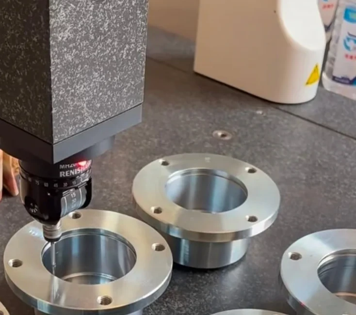 CMM probe measuring a bore on the granite table of a coordinate measuring machine