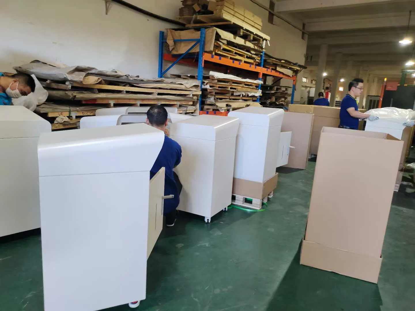 Workers assembling custom metal cabinets in Fulei Metal workshop before export packing