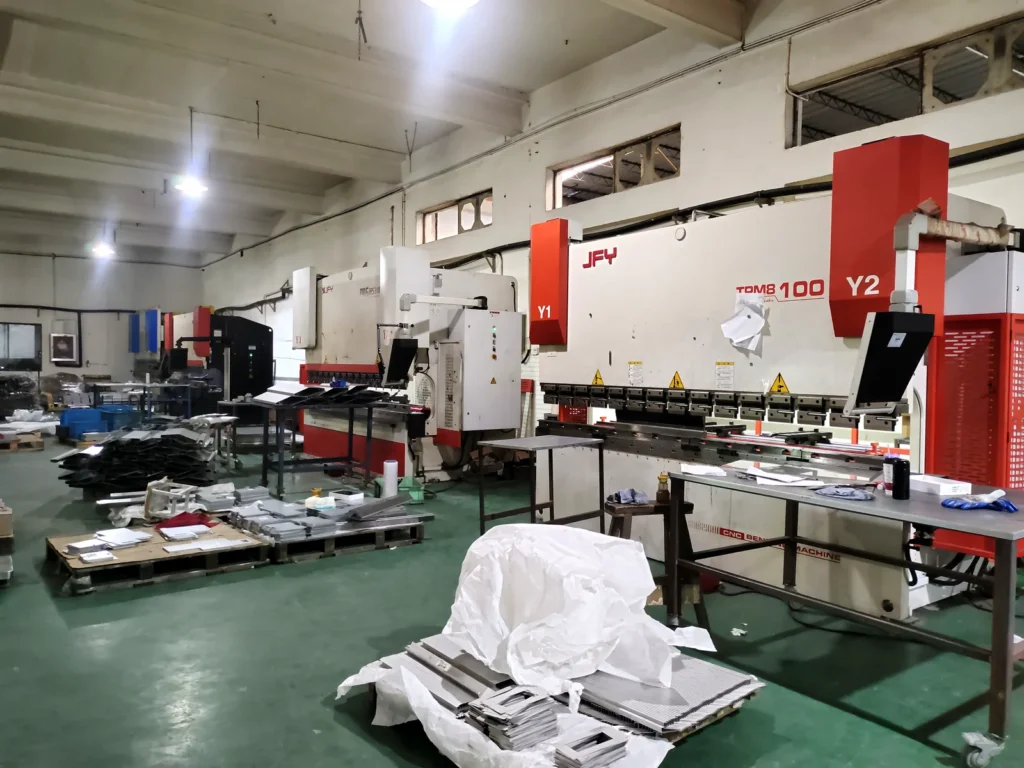 Fulei Metal sheet metal fabrication workshop in Ningbo, China, showing the CNC press brake bending station and prepared stainless steel parts