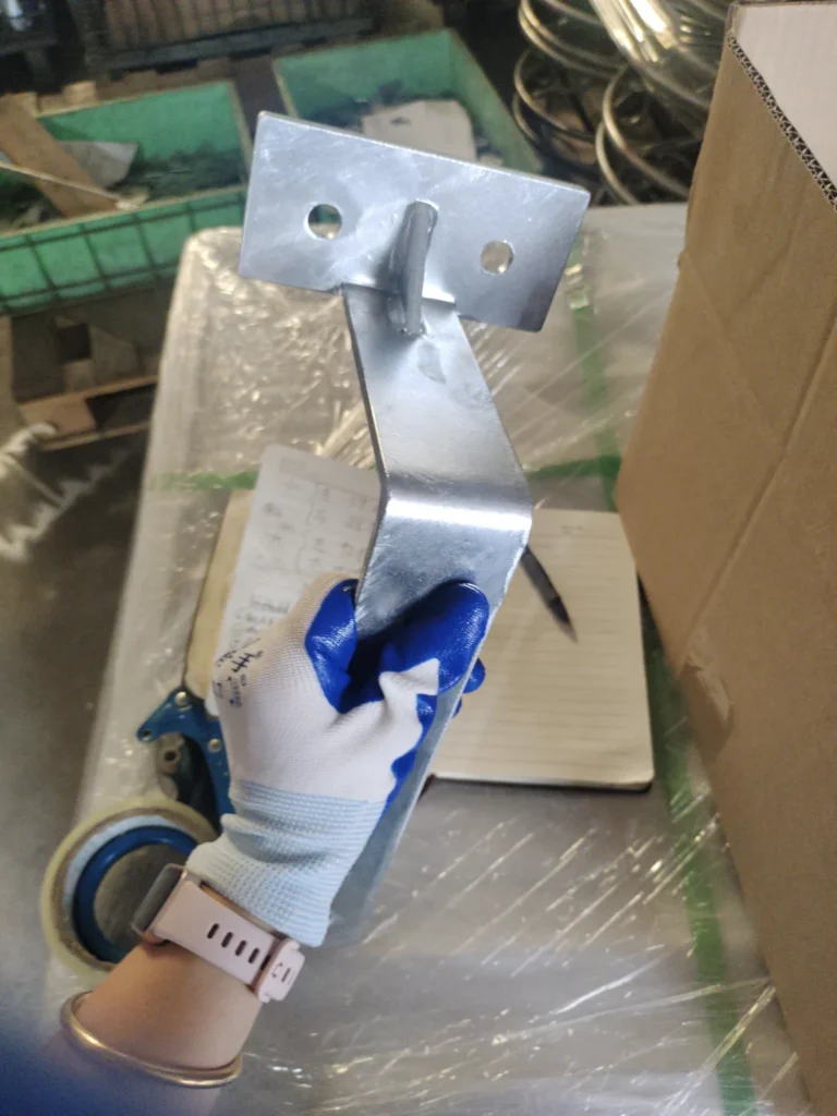 Galvanized sheet metal bracket surface inspection with holes and welded area visible