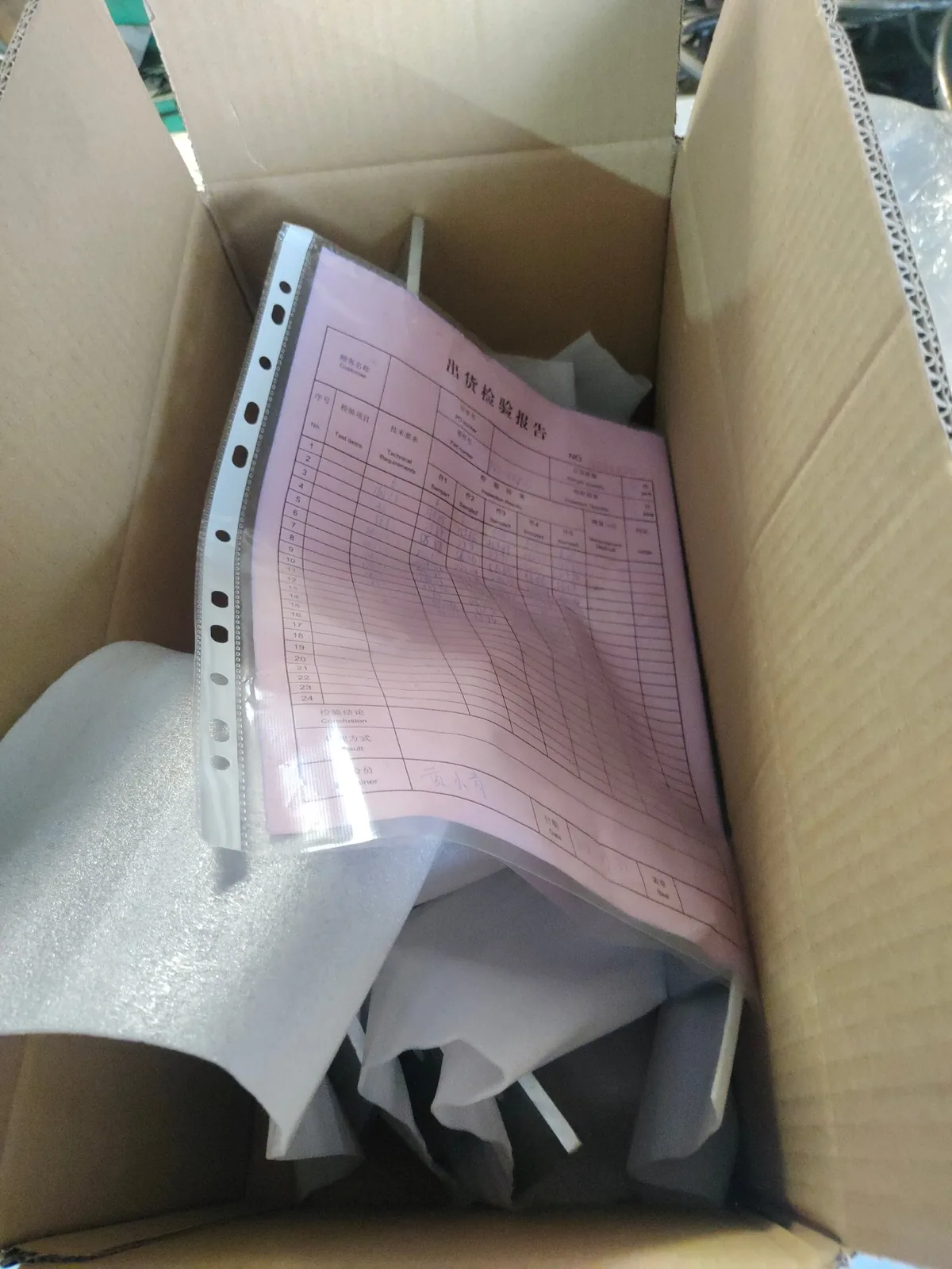 Signed outgoing inspection report placed inside the export carton with protective packing