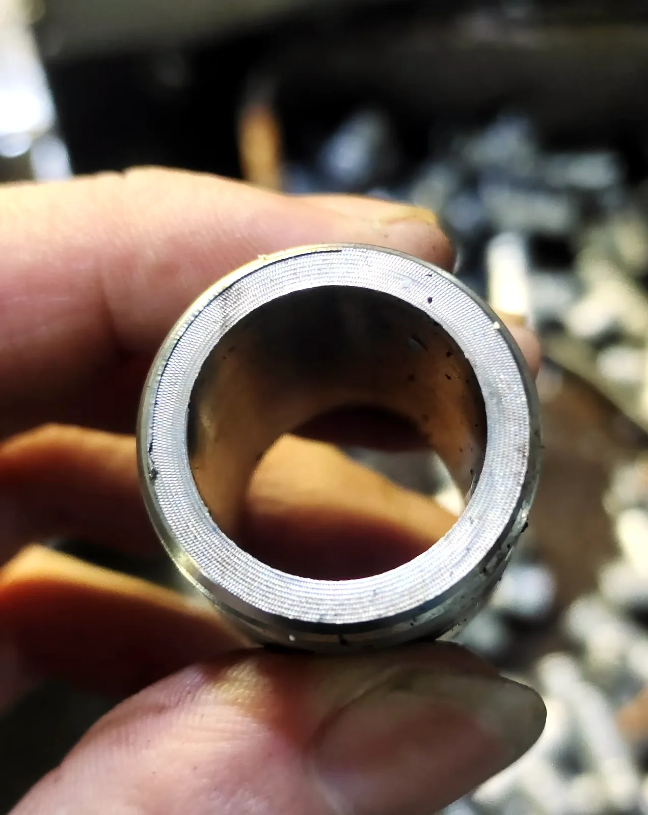 Cut tube end with visible burr and raised edge after saw cutting and punching
